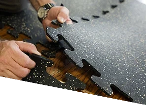 Hands-connecting-interlocking-speckled-rubber-gym-floor-tiles